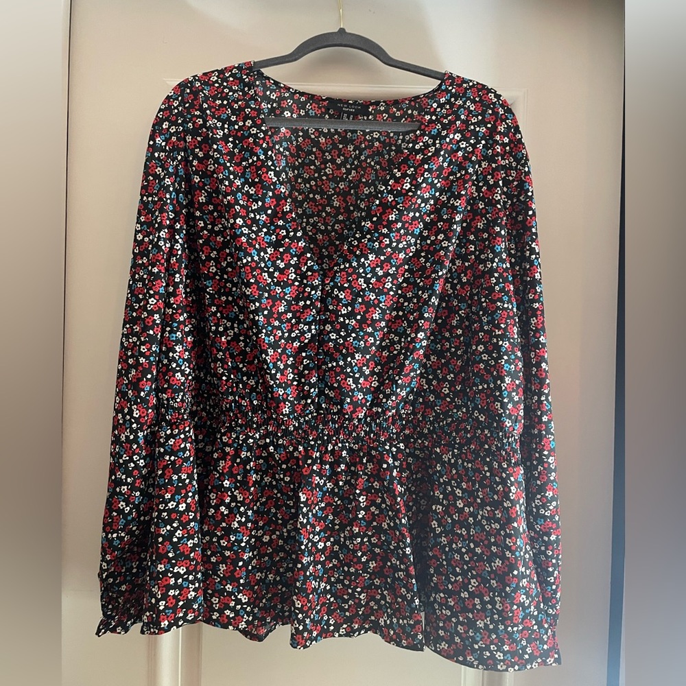 Red/white/blue flowers on black top.